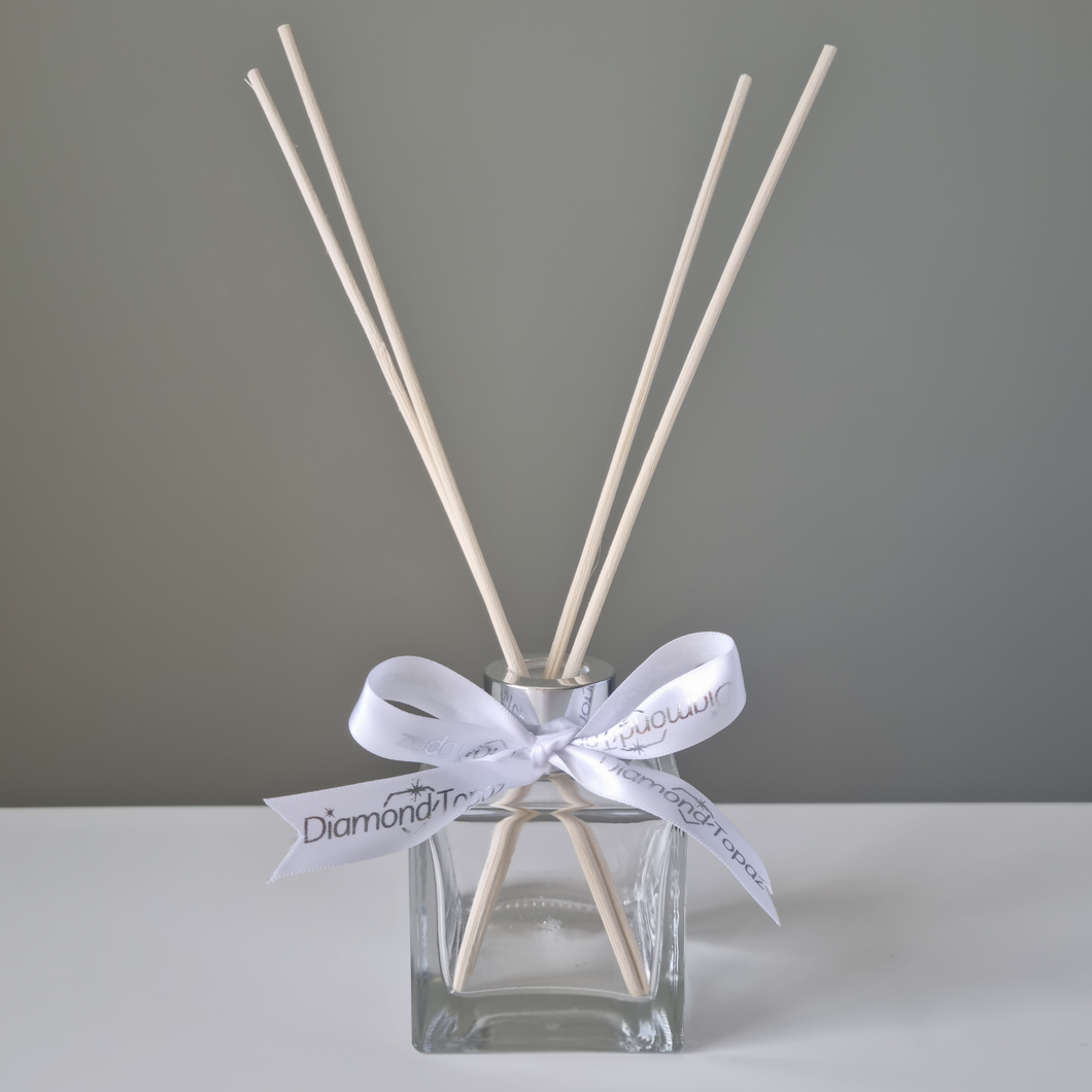 Clear square glass diffuser, with natural reeds and white & silver robbon