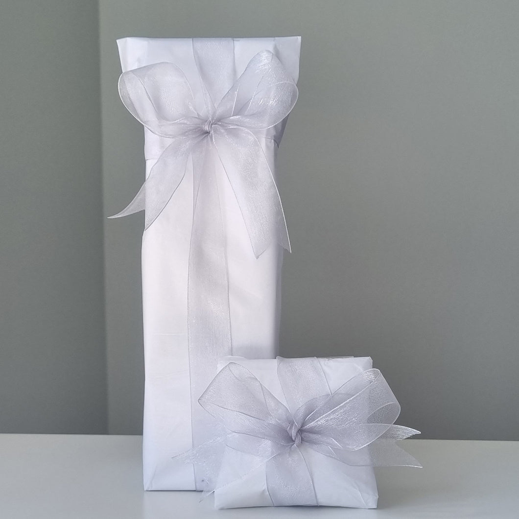 White tissue paper with silver ribbon gift wrap